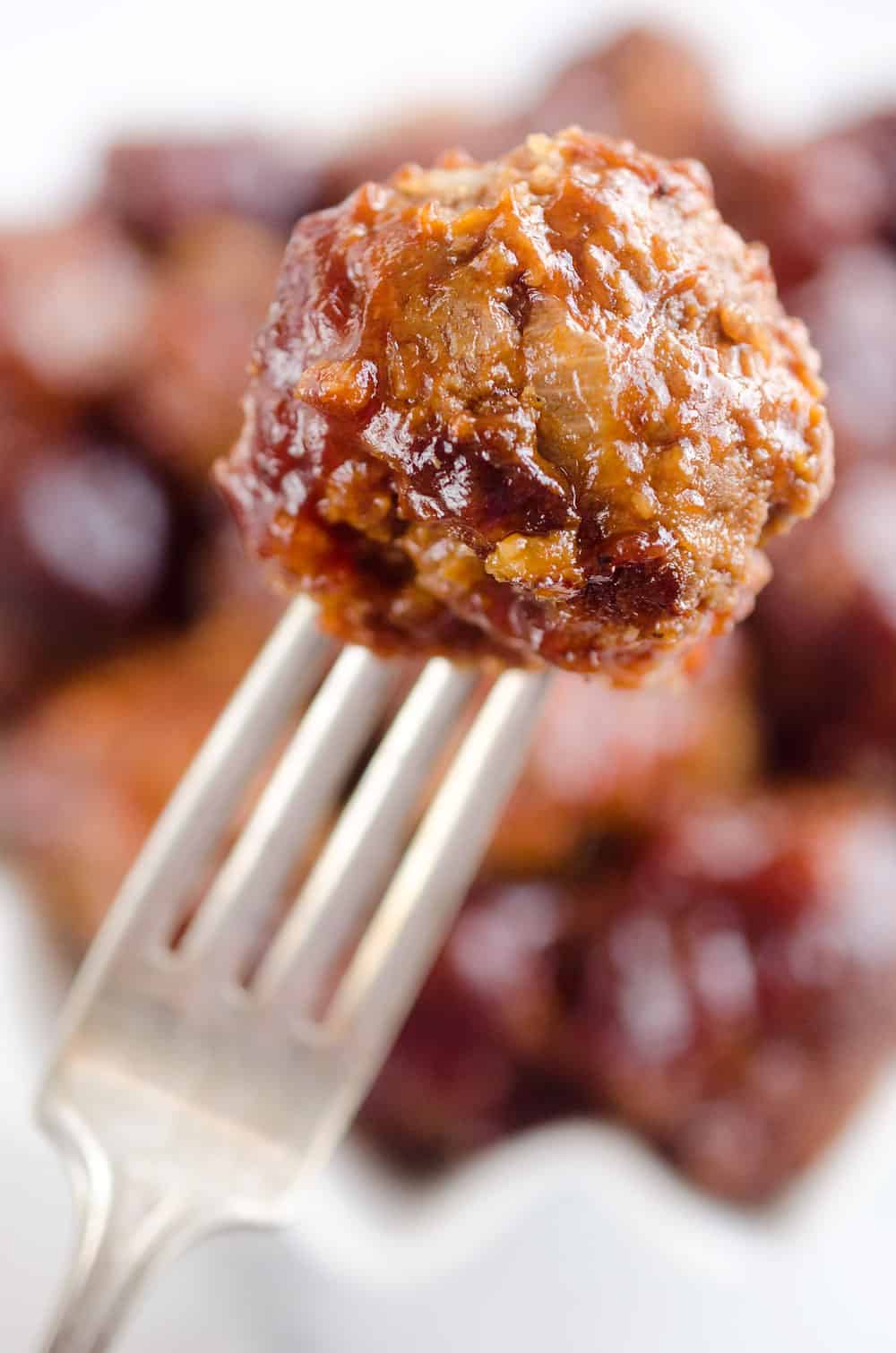 Crock Pot Cheddar BBQ Meatballs make for a flavor packed dinner paired with potatoes or a fantastic appetizer for the big game or holiday bash! Tender beef meatballs loaded with onion and cheese are simmered in your favorite BBQ sauce for a wonderful recipe made in your slow cooker. 