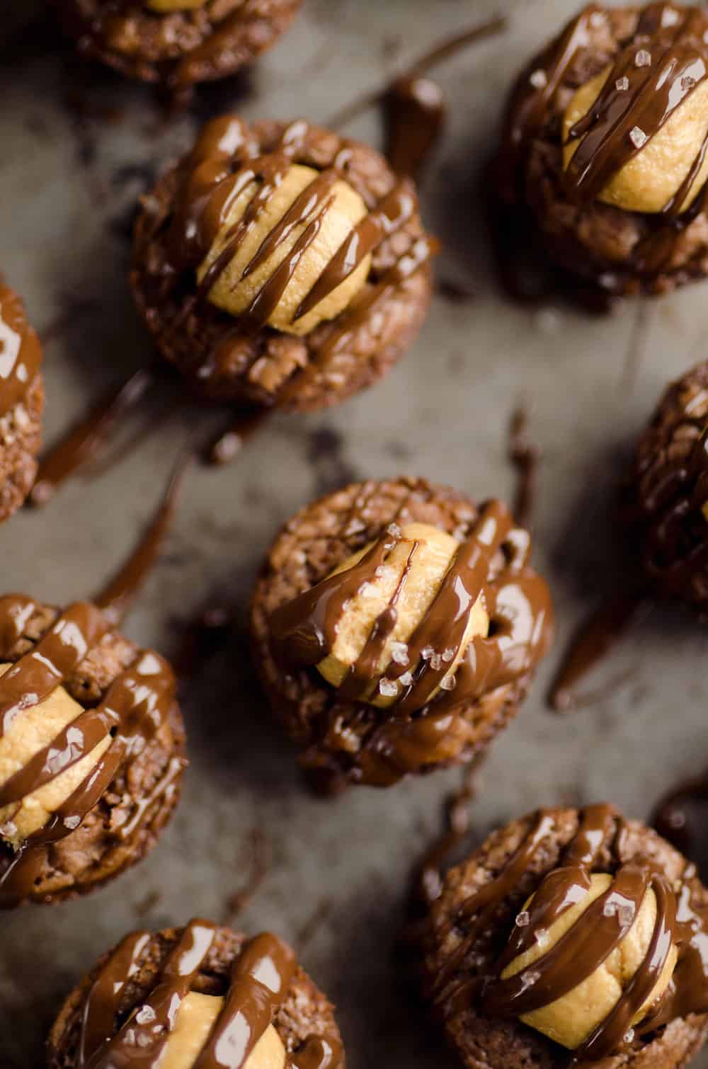 Peanut Butter Buckeye Brownie Cups are the best new dessert recipe you will try! Mini brownies are topped with a Reese's peanut butter filling and drizzled with dark chocolate and sea salt for a spectacular sweet.