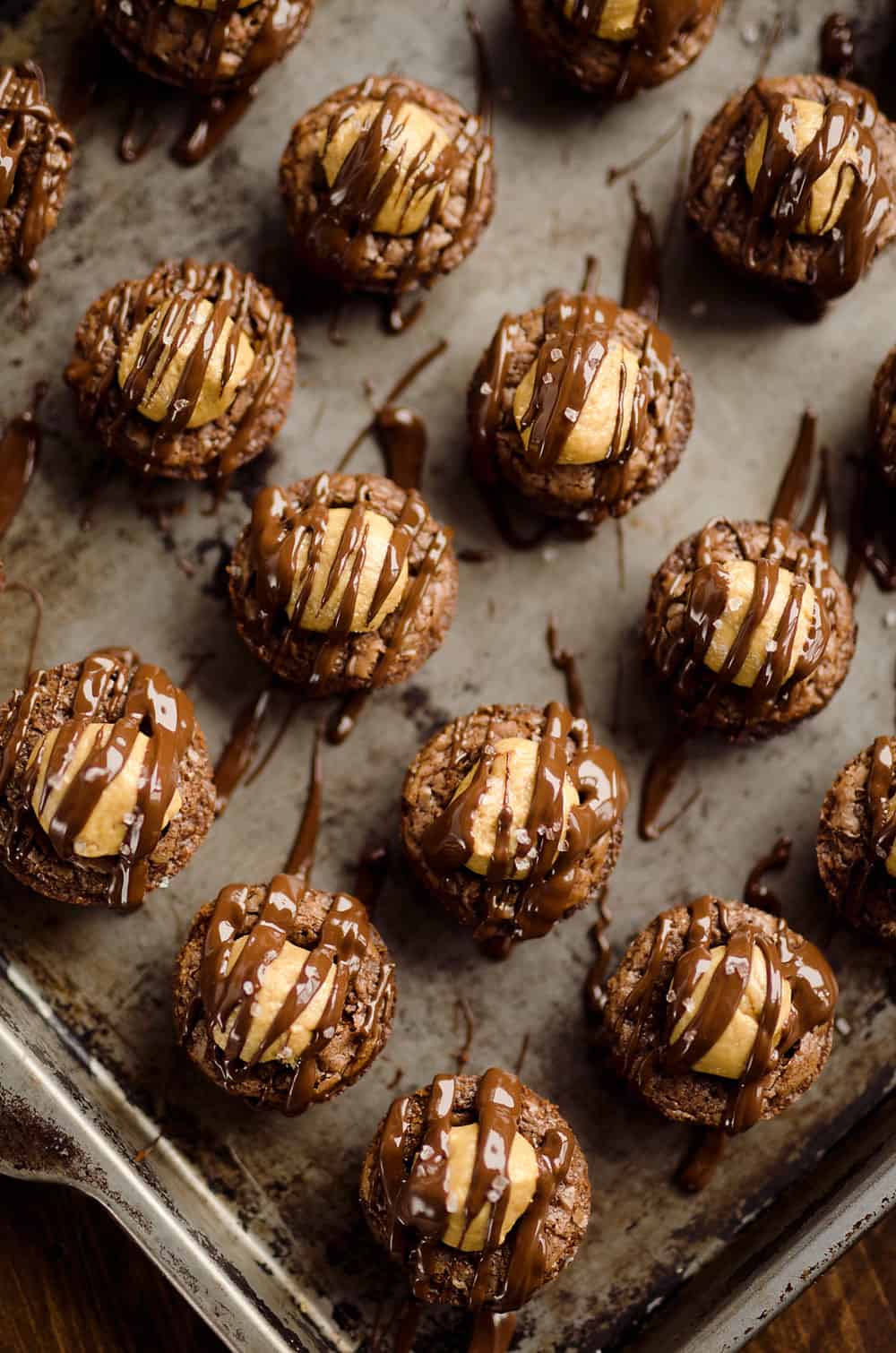 Peanut Butter Buckeye Brownie Cups are the best new dessert recipe you will try! Mini brownies are topped with a Reese's peanut butter filling and drizzled with dark chocolate and sea salt for a spectacular sweet.