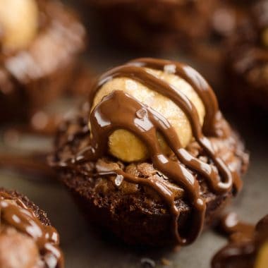 Peanut Butter Buckeye Brownie Cups are the best new dessert recipe you will try! Mini brownies are topped with a Reese's peanut butter filling and drizzled with dark chocolate and sea salt for a spectacular sweet.