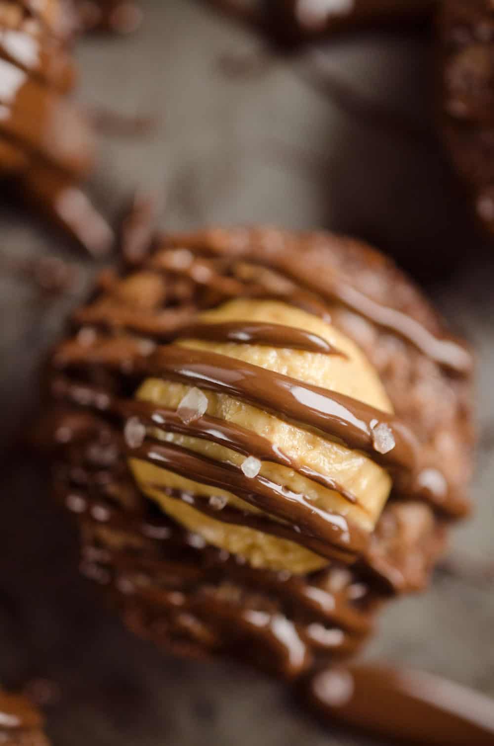 Peanut Butter Buckeye Brownie Cups are the best new dessert recipe you will try! Mini brownies are topped with a Reese's peanut butter filling and drizzled with dark chocolate and sea salt for a spectacular sweet.