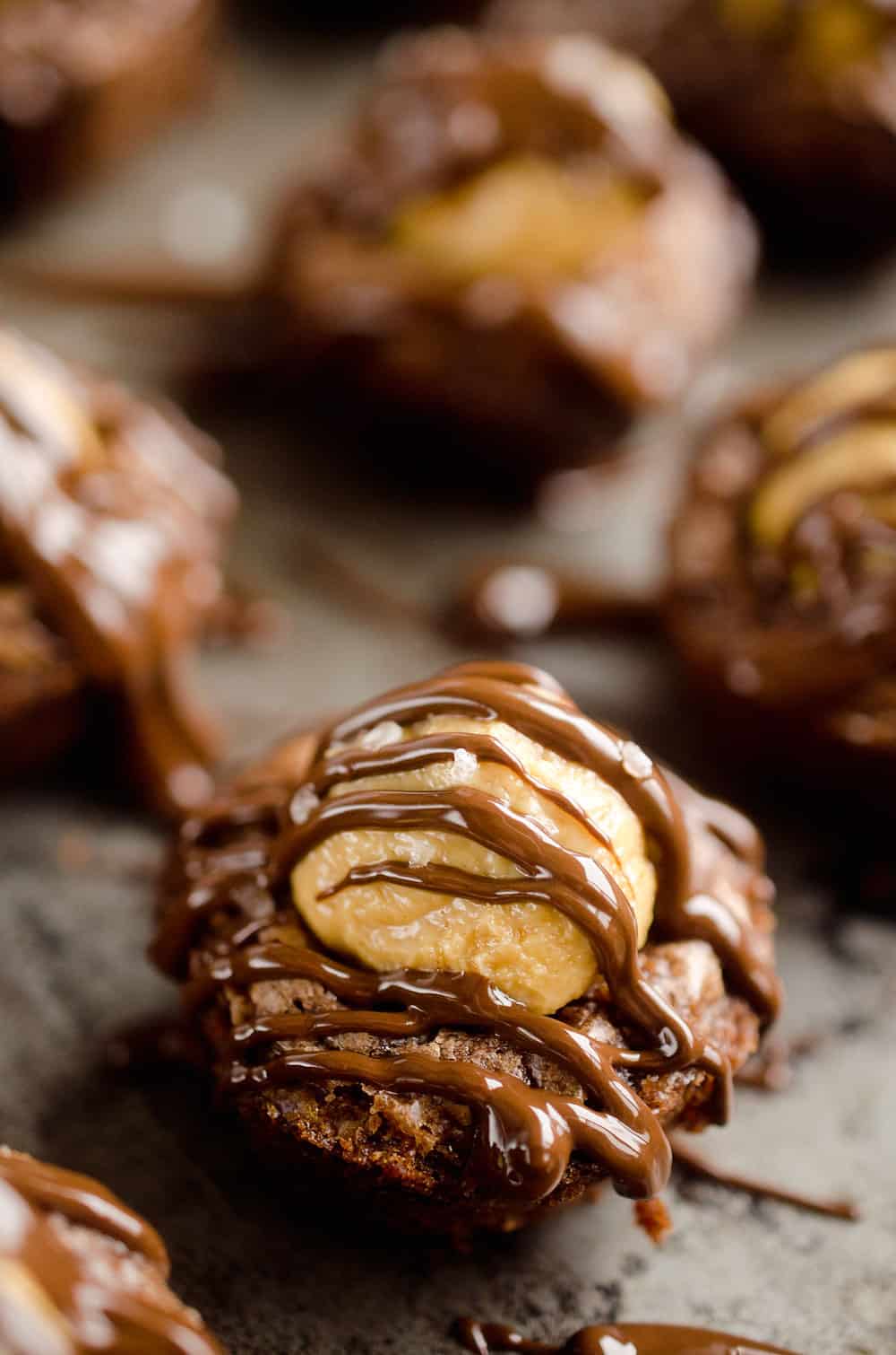 Peanut Butter Buckeye Brownie Cups are the best new dessert recipe you will try! Mini brownies are topped with a Reese's peanut butter filling and drizzled with dark chocolate and sea salt for a spectacular sweet.