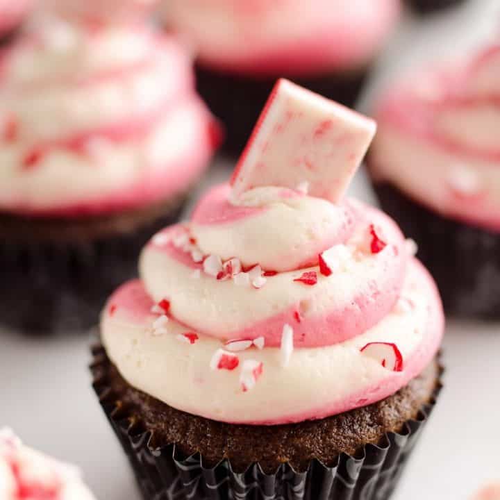 Peppermint Chocolate Candy Cane Cupcakes are a beautifully festive dessert perfect for the holidays! Moist homemade chocolate cupcakes are topped with a candy cane swirl of buttercream and topped with peppermint for a seasonal treat.