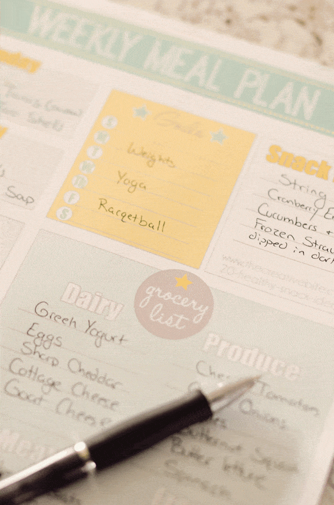Free Printable Weekly Meal Planner filled out on table with pen