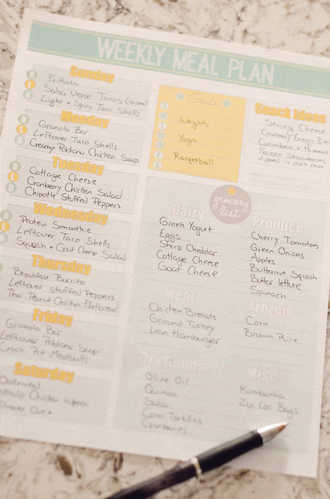 Free Printable Weekly Meal Planner filled out on table with pen