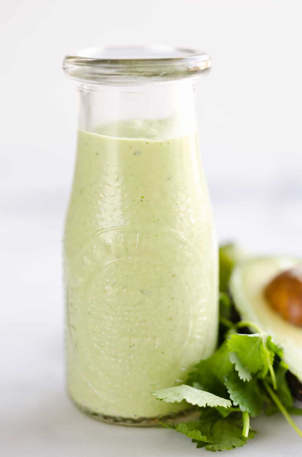 Avocado Lime Green Goddess Sauce is a light and healthy dressing made with creamy Greek yogurt, avocado, garlic and herbs. It is perfect on a salad or as a dipping sauce for chicken and steak!