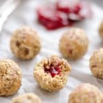 PB&J Surprise Energy Bites are a fun and healthy no bake snack with a peanut butter and oat mixture and a surprise pop of strawberry jelly on the inside.