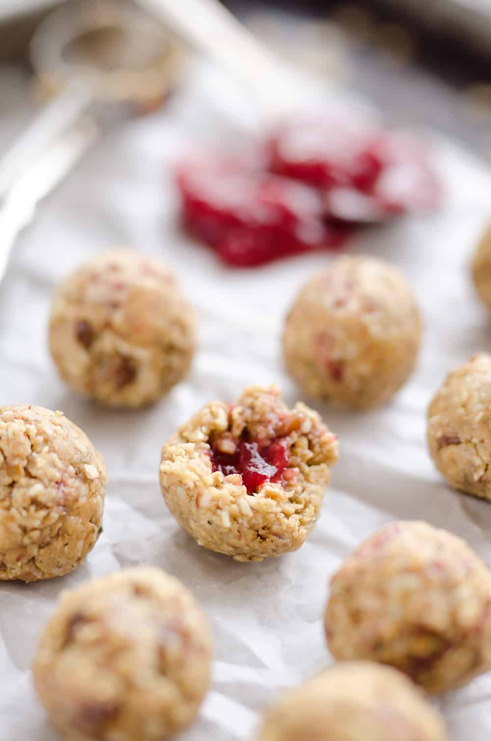 PB&J Surprise Energy Bites are a fun and healthy no bake snack with a peanut butter and oat mixture and a surprise pop of strawberry jelly on the inside.