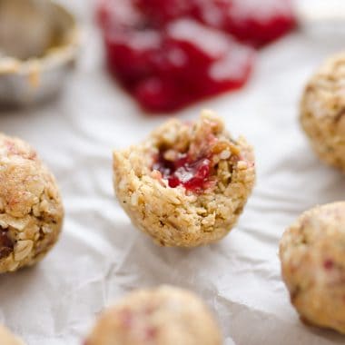 PB&J Surprise Energy Bites are a fun and healthy no bake snack with a peanut butter and oat mixture and a surprise pop of strawberry jelly on the inside.