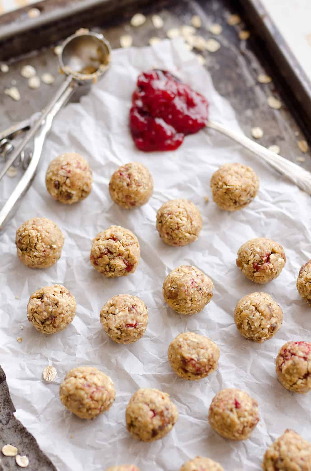 PB&J Surprise Energy Bites are a fun and healthy no bake snack with a peanut butter and oat mixture and a surprise pop of strawberry jelly on the inside. 
