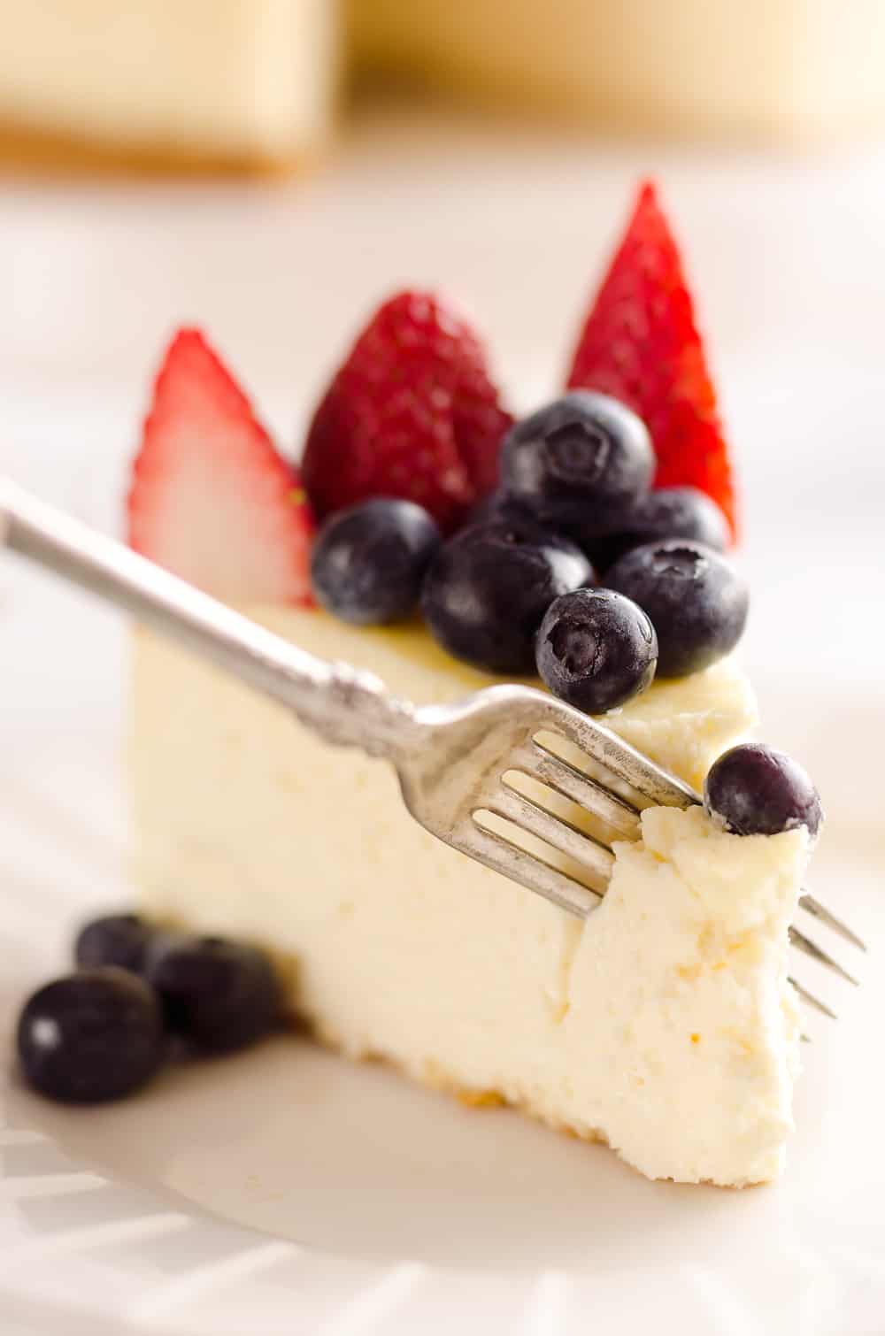 Creamy New York Cheesecake with Fresh Fruit is a rich and decadent dessert recipe that is sure to impress all your dinner guests! 