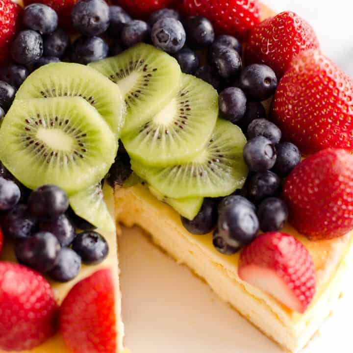 Creamy New York Cheesecake with Fresh Fruit is a rich and decadent dessert recipe that is sure to impress all your dinner guests!