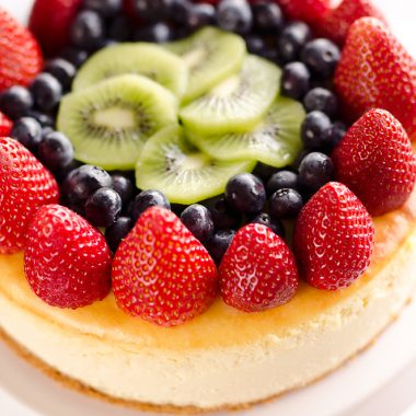 Creamy New York Cheesecake with Fresh Fruit is a rich and decadent dessert recipe that is sure to impress all your dinner guests!