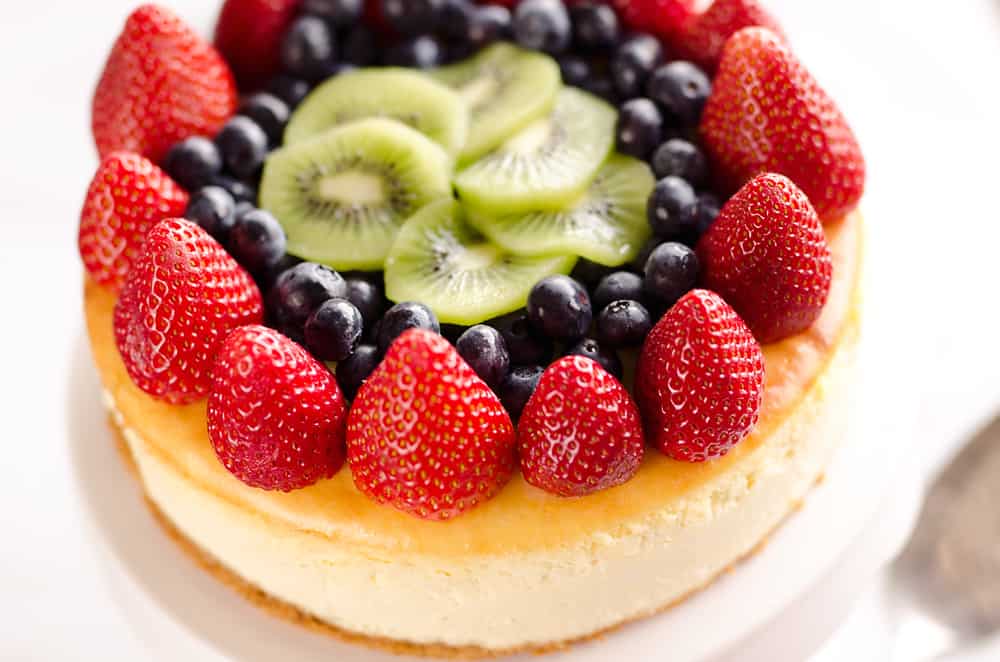 Creamy New York Cheesecake with Fresh Fruit is a rich and decadent dessert recipe that is sure to impress all your dinner guests! 