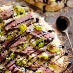 Steak, Goat Cheese & Roasted Brussels Sprouts Flatbread with spoonful of balsamic glaze