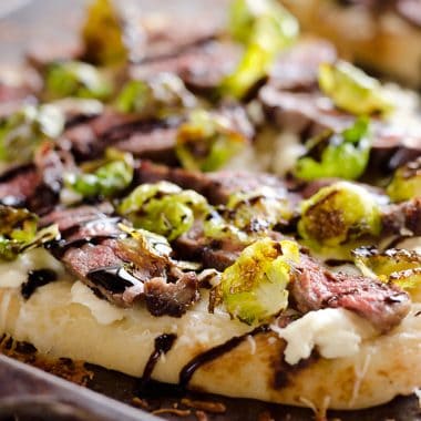 Steak, Goat Cheese & Roasted Brussels Sprouts Flatbread on sheet pan with browned cheese