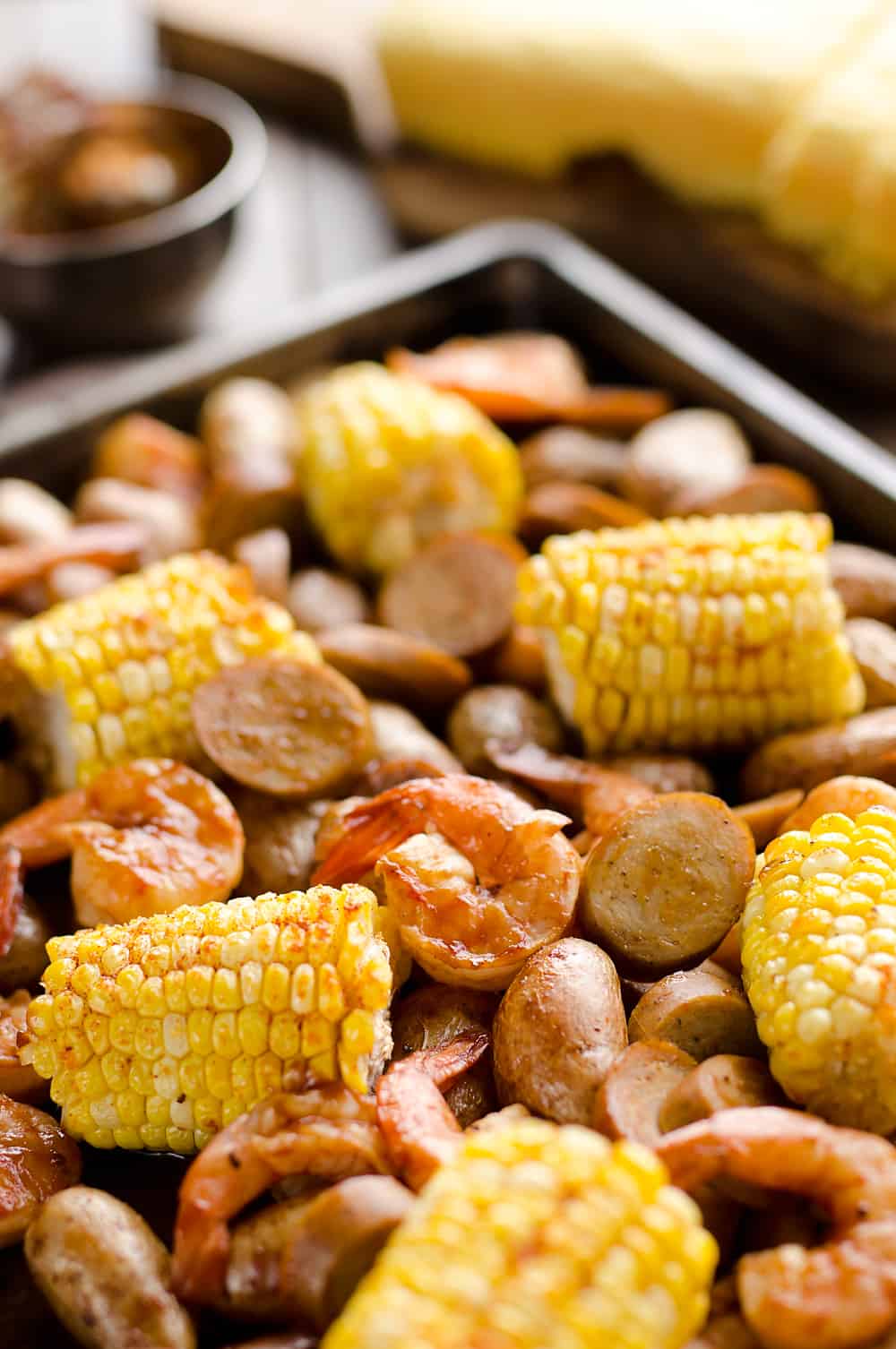 BBQ Shrimp & Sausage Sheet Pan Dinner is an easy and wholesome recipe perfect for a weeknight family dinner. Roasted sweet corn and potatoes are paired with BBQ shrimp and Gold'n Plump Hickory Smoked Sliced Chicken Sausage for a comforting low-fat meal!