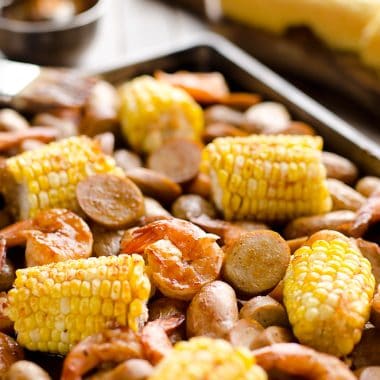 BBQ Shrimp & Sausage Sheet Pan Dinner is an easy and wholesome recipe perfect for a weeknight family dinner. Roasted sweet corn and potatoes are paired with BBQ shrimp and Gold'n Plump Hickory Smoked Sliced Chicken Sausage for a comforting low-fat meal!