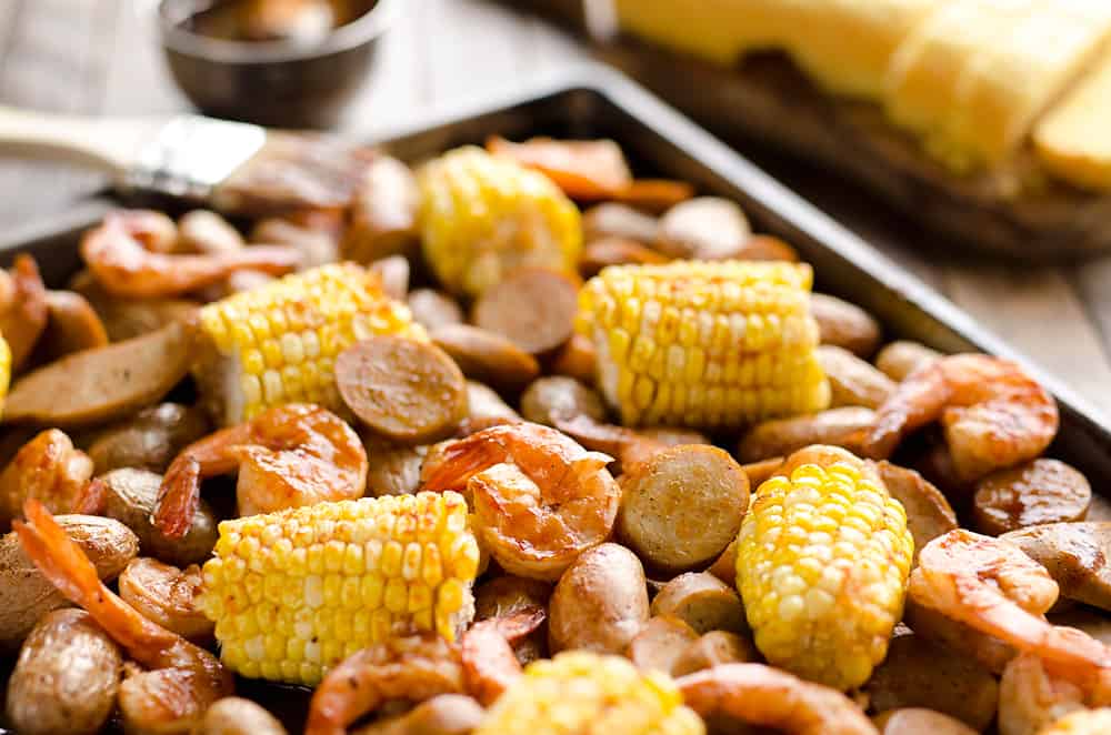 BBQ Shrimp & Sausage Sheet Pan Dinner is an easy and wholesome recipe perfect for a weeknight family dinner. Roasted sweet corn and potatoes are paired with BBQ shrimp and Gold'n Plump Hickory Smoked Sliced Chicken Sausage for a comforting low-fat meal!