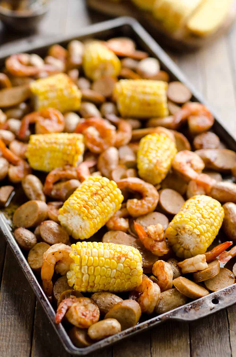 BBQ Shrimp & Sausage Sheet Pan Dinner is an easy and wholesome recipe perfect for a weeknight family dinner. Roasted sweet corn and potatoes are paired with BBQ shrimp and Gold'n Plump Hickory Smoked Sliced Chicken Sausage for a comforting low-fat meal!