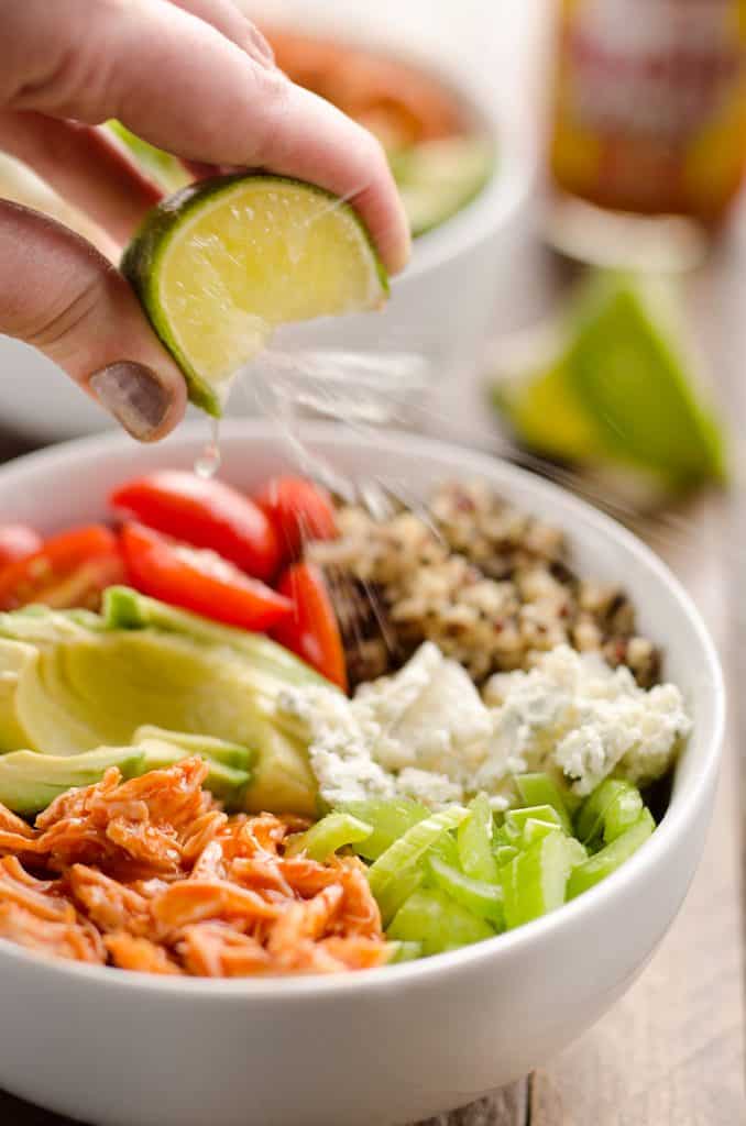 Buffalo Chicken & Quinoa Veggie Bowls are a light and healthy dinner recipe loaded with wholesome vegetables and grains, shredded chicken tossed in spicy buffalo sauce and bleu cheese crumbles for amazing flavor!