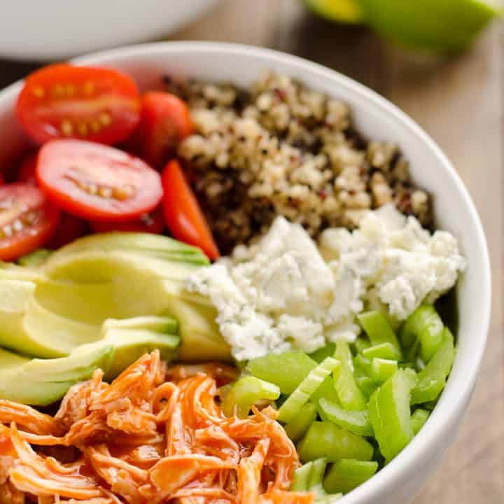 Buffalo Chicken & Quinoa Veggie Bowls are a light and healthy dinner recipe loaded with wholesome vegetables and grains, shredded chicken tossed in spicy buffalo sauce and bleu cheese crumbles for amazing flavor!