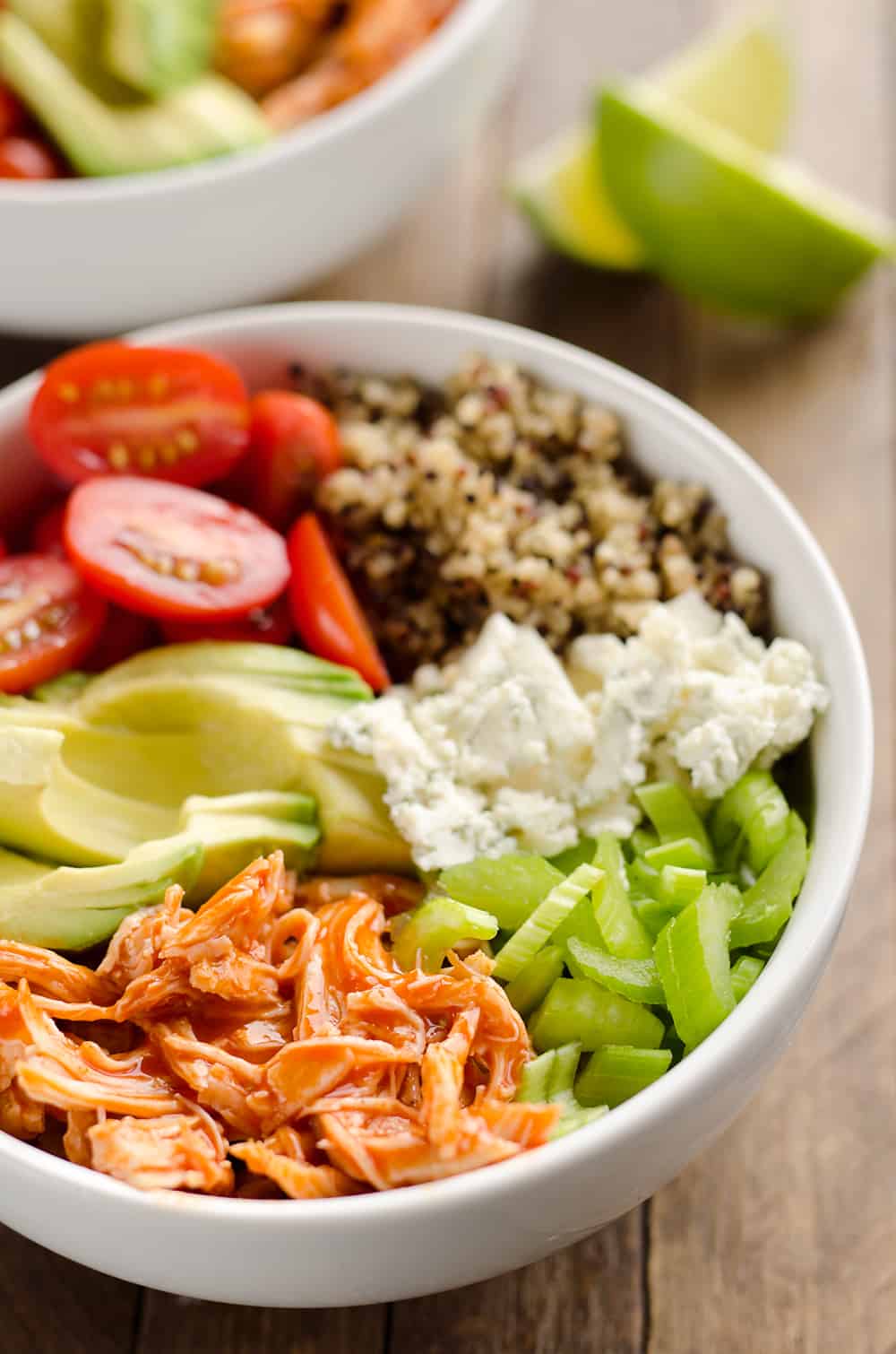 Buffalo Chicken & Quinoa Veggie Bowls are a light and healthy dinner recipe loaded with wholesome vegetables and grains, shredded chicken tossed in spicy buffalo sauce and bleu cheese crumbles for amazing flavor!