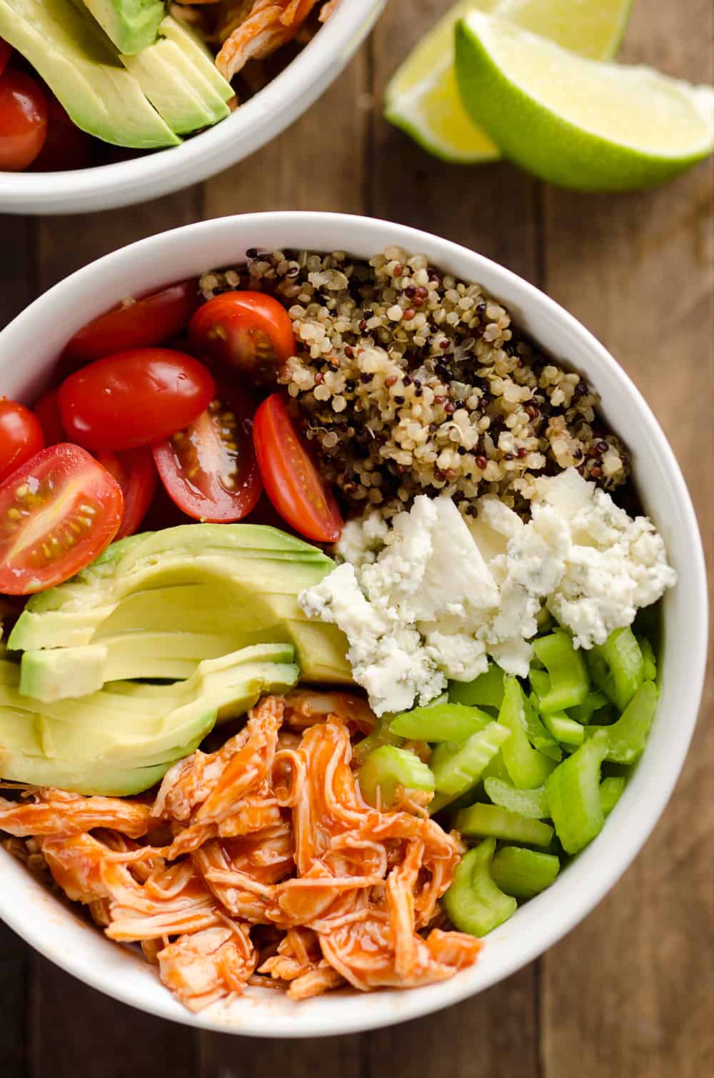 Buffalo Chicken & Quinoa Veggie Bowls are a light and healthy dinner recipe loaded with wholesome vegetables and grains, shredded chicken tossed in spicy buffalo sauce and bleu cheese crumbles for amazing flavor!