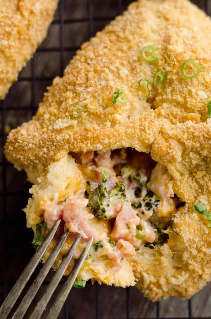 Cheesy Hot Ham & Broccoli Crescent Pockets are a family friendly dinner idea perfect for using up leftover ham! Flaky crescents are filled with a cheddar, broccoli and ham mixture and topped with buttery croutons.