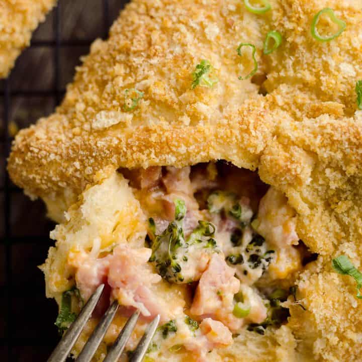 Cheesy Hot Ham & Broccoli Crescent Pockets are a family friendly dinner idea perfect for using up leftover ham! Flaky crescents are filled with a cheddar, broccoli and ham mixture and topped with buttery croutons.