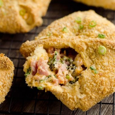 Cheesy Hot Ham & Broccoli Crescent Pockets are a family friendly dinner idea perfect for using up leftover ham! Flaky crescents are filled with a cheddar, broccoli and ham mixture and topped with buttery croutons.