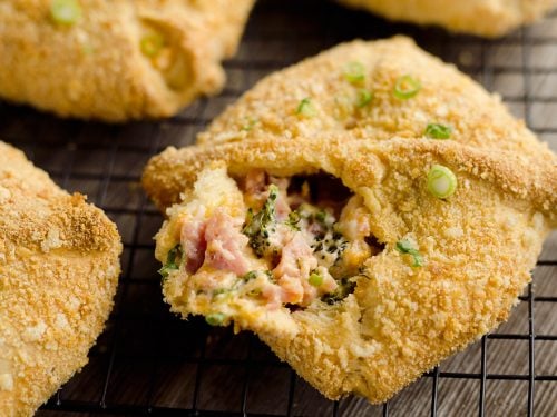 Cheesy Hot Ham & Broccoli Crescent Pockets are a family friendly dinner idea perfect for using up leftover ham! Flaky crescents are filled with a cheddar, broccoli and ham mixture and topped with buttery croutons.