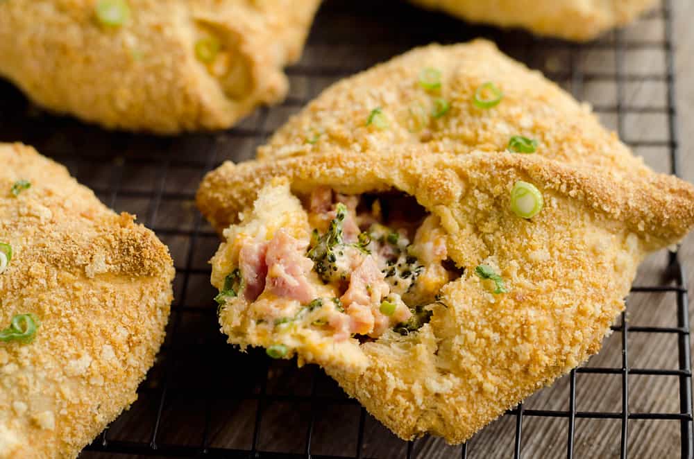 Cheesy Hot Ham & Broccoli Crescent Pockets are a family friendly dinner idea perfect for using up leftover ham! Flaky crescents are filled with a cheddar, broccoli and ham mixture and topped with buttery croutons. 