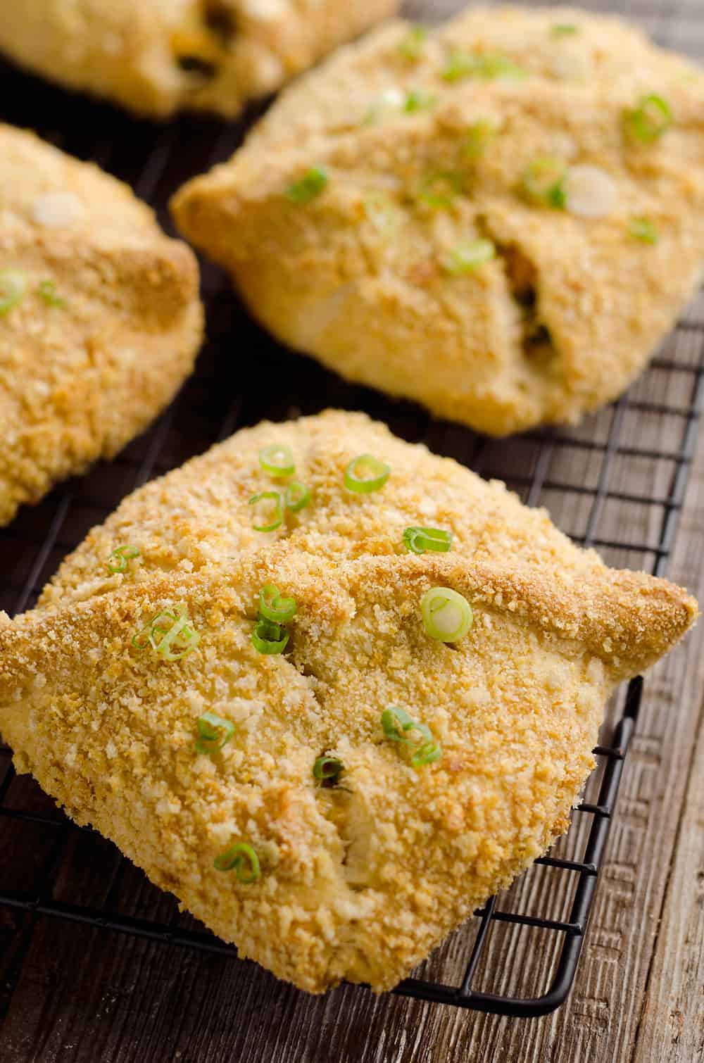 Cheesy Hot Ham & Broccoli Crescent Pockets are a family friendly dinner idea perfect for using up leftover ham! Flaky crescents are filled with a cheddar, broccoli and ham mixture and topped with buttery croutons. 