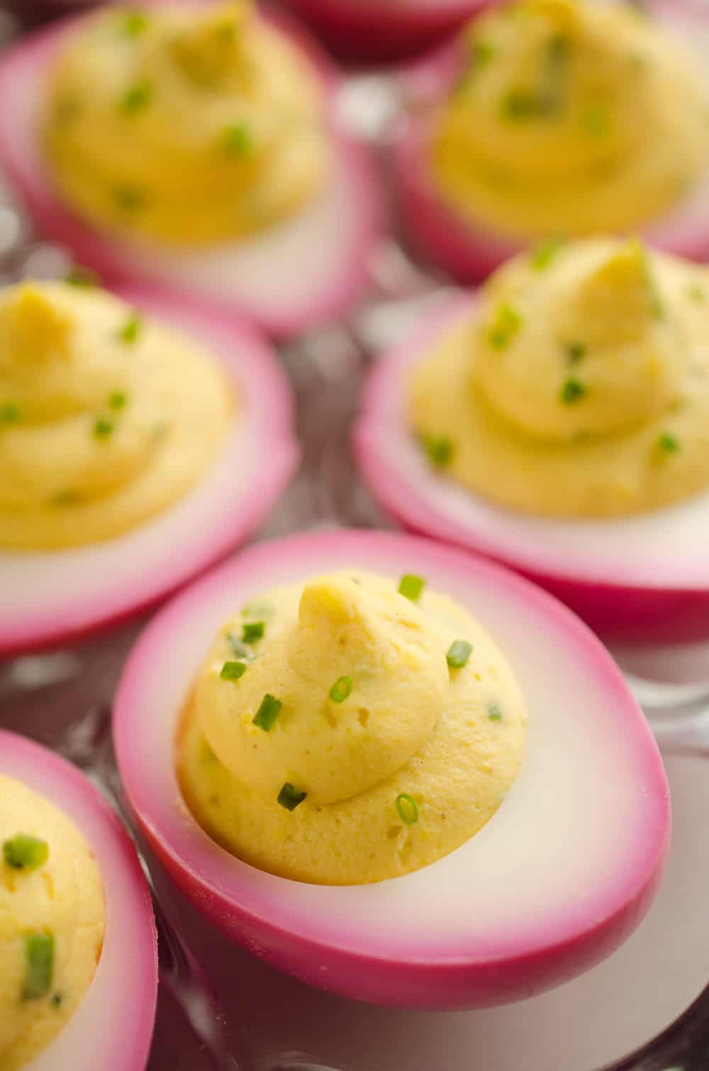 Pink Pickled Deviled Eggs are a beautiful side dish or appetizer perfect for your holiday table. Hard boiled eggs are lightly pickled in beet juice and vinegar for the unique color that is sure to impress your guests!
