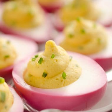 pink deviled eggs on tray