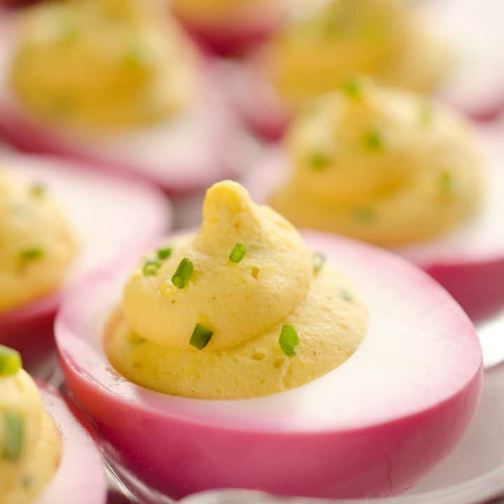 pink deviled eggs on tray