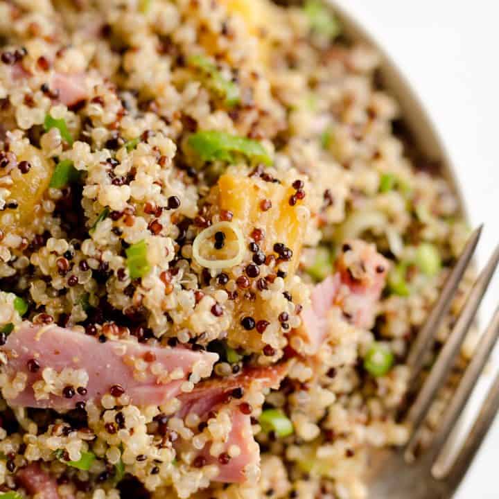 Roasted Pineapple & Ham Quinoa Salad is an easy recipe using up leftover ham with the perfect combination of sweet, salty and smokey flavors. Crunchy quinoa and oven roasted pineapple and ham are tossed with a Light Honey Dijon Vinaigrette for an easy 5 ingredient salad.