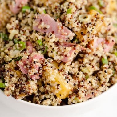 Roasted Pineapple & Ham Quinoa Salad is an easy recipe using up leftover ham with the perfect combination of sweet, salty and smokey flavors. Crunchy quinoa and oven roasted pineapple and ham are tossed with a Light Honey Dijon Vinaigrette for an easy 5 ingredient salad.