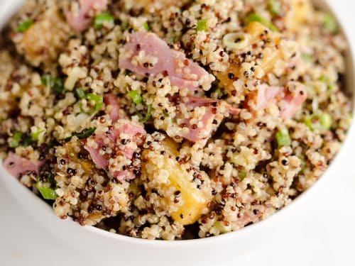 Roasted Pineapple & Ham Quinoa Salad is an easy recipe using up leftover ham with the perfect combination of sweet, salty and smokey flavors. Crunchy quinoa and oven roasted pineapple and ham are tossed with a Light Honey Dijon Vinaigrette for an easy 5 ingredient salad.