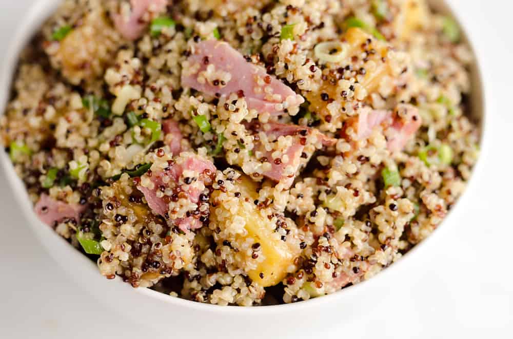 Roasted Pineapple & Ham Quinoa Salad is an easy recipe using up leftover ham with the perfect combination of sweet, salty and smokey flavors. Crunchy quinoa and oven roasted pineapple and ham are tossed with a Light Honey Dijon Vinaigrette for an easy 5 ingredient salad. 