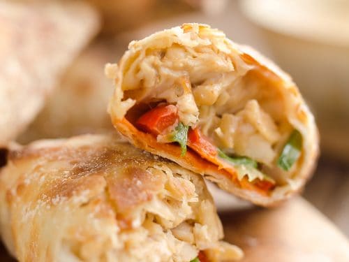 Airfryer Baked Thai Peanut Chicken Egg Rolls are a light and healthy recipe made in your Airfryer or oven. Chicken is tossed with creamy Thai peanut sauce, carrots, red peppers and green onions and rolled in crispy egg roll wrappers for a flavorful dinner you can make in just 20 minutes.