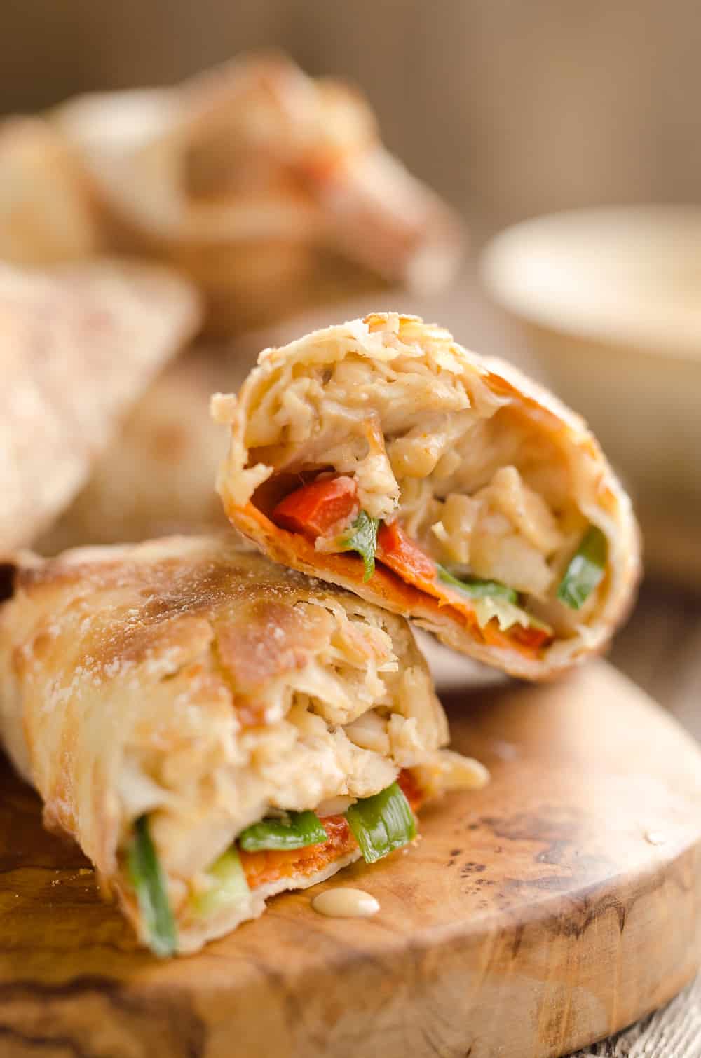 Airfryer Baked Thai Peanut Chicken Egg Rolls are a light and healthy recipe made in your Airfryer or oven. Chicken is tossed with creamy Thai peanut sauce, carrots, red peppers and green onions and rolled in crispy egg roll wrappers for a flavorful dinner you can make in just 20 minutes. 