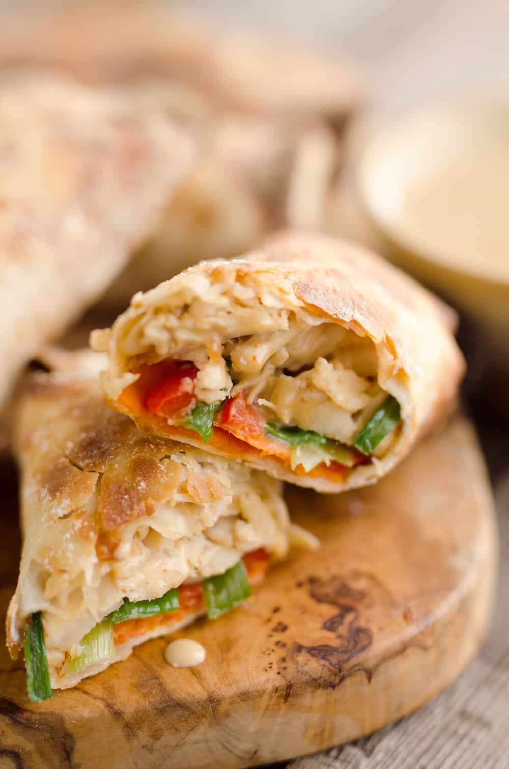 Airfryer Baked Thai Peanut Chicken Egg Rolls are a light and healthy recipe made in your Airfryer or oven. Chicken is tossed with creamy Thai peanut sauce, carrots, red peppers and green onions and rolled in crispy egg roll wrappers for a flavorful dinner you can make in just 20 minutes. 
