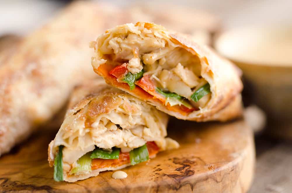 Airfryer Baked Thai Peanut Chicken Egg Rolls are a light and healthy recipe made in your Airfryer or oven. Chicken is tossed with creamy Thai peanut sauce, carrots, red peppers and green onions and rolled in crispy egg roll wrappers for a flavorful dinner you can make in just 20 minutes. 