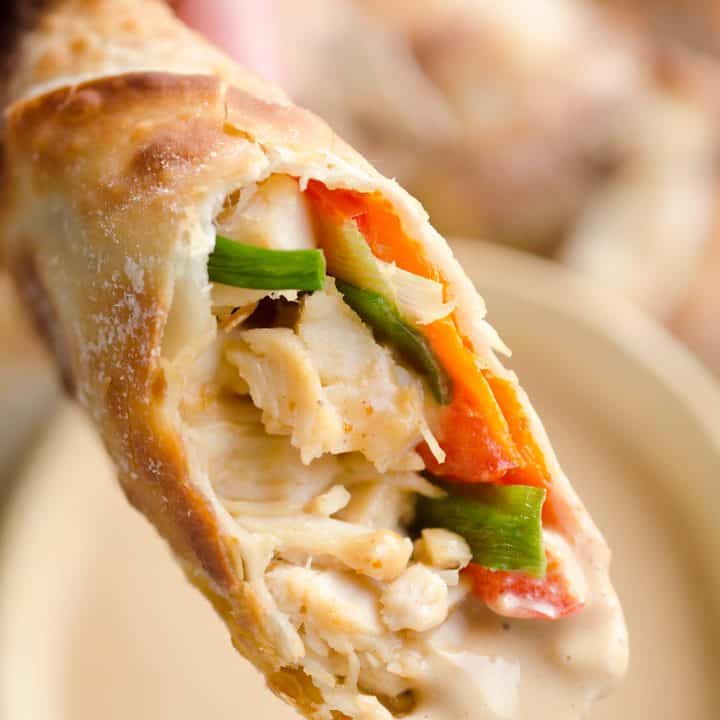 Airfryer Baked Thai Peanut Chicken Egg Rolls are a light and healthy recipe made in your Airfryer or oven. Chicken is tossed with creamy Thai peanut sauce, carrots, red peppers and green onions and rolled in crispy egg roll wrappers for a flavorful dinner you can make in just 20 minutes.