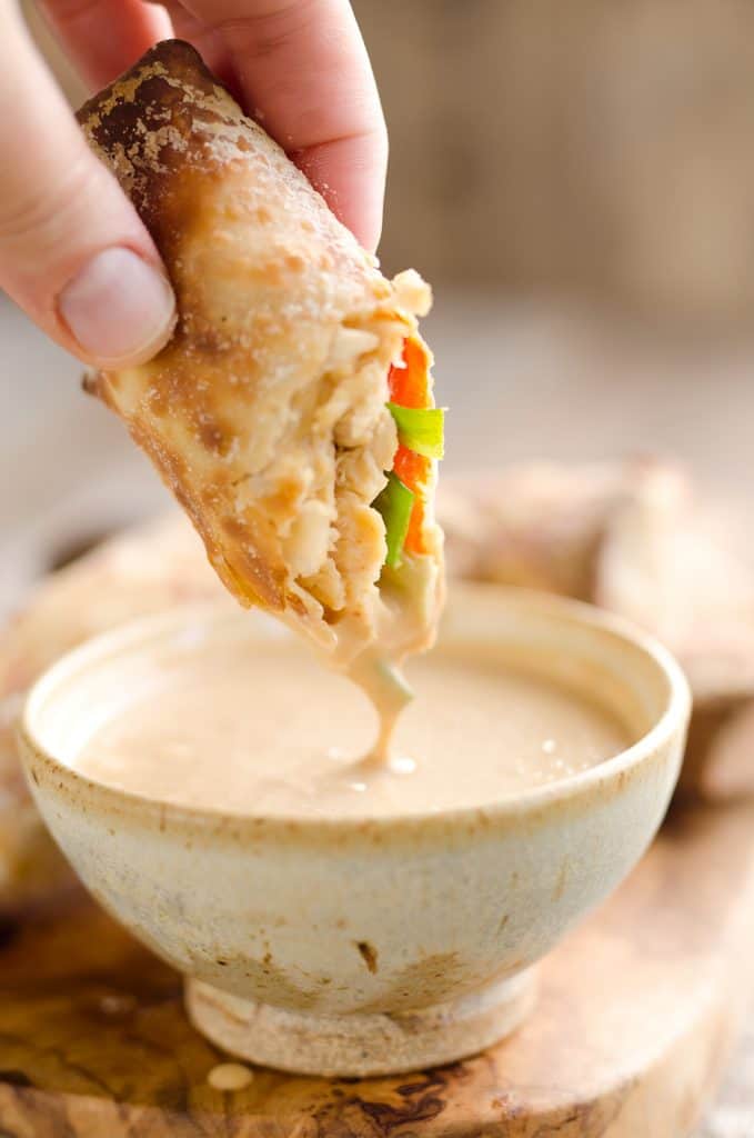 Airfryer Baked Thai Peanut Chicken Egg Rolls are a light and healthy recipe made in your Airfryer or oven. Chicken is tossed with creamy Thai peanut sauce, carrots, red peppers and green onions and rolled in crispy egg roll wrappers for a flavorful dinner you can make in just 20 minutes.