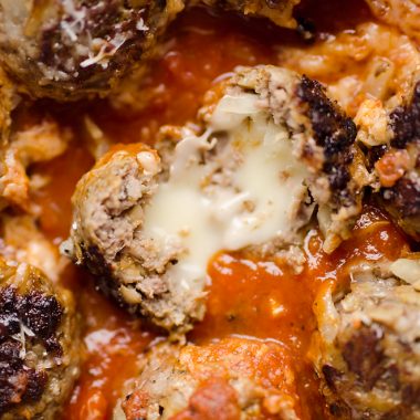 Provolone Stuffed Pesto Meatball Skillet is a hearty dinner made with classic Italian flavors. Provolone cheese is stuffed inside lean hamburger and simmered in marinara for a healthy dinner idea the whole family will love.