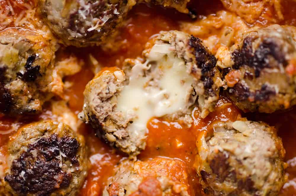 Provolone Stuffed Pesto Meatball Skillet is a hearty dinner made with classic Italian flavors. Provolone cheese is stuffed inside lean hamburger and simmered in marinara for a healthy dinner idea the whole family will love. 