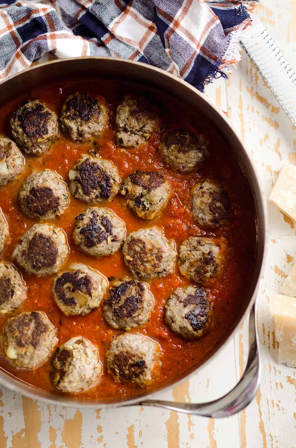 Provolone Stuffed Pesto Meatball Skillet is a hearty dinner made with classic Italian flavors. Provolone cheese is stuffed inside lean hamburger and simmered in marinara for a healthy dinner idea the whole family will love. 